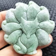 A polished green jade gemstone beside a traditional Chinese jade carving