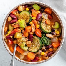 A plant-based meal served with vegetables, beans, and grains.