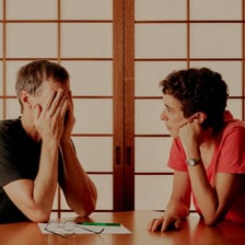 Two people having a serious conversation to resolve a disagreement