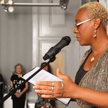 A master of ceremonies speaking into a microphone.
