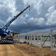 Construction workers putting up a building frame