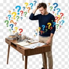 A person looking confused while surrounded by papers.