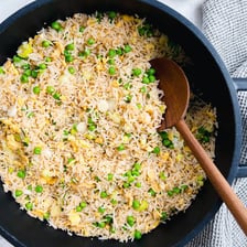 Green peas mixed into a serving of fried rice