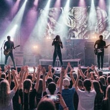 A darkly styled band performing onstage at a concert
