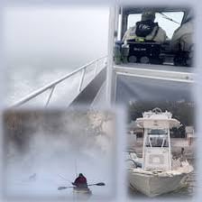 Boats in a harbor surrounded by dense fog.