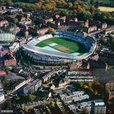 An aerial view of an oval-shaped cricket field