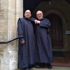 An abbot wearing monastic robes inside a monastery