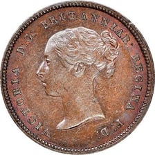 A British halfpenny coin shown with farthing coins.