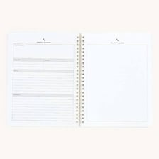 A person beginning a new project in a blank notebook.