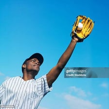 A baseball player wearing a fielding mitt