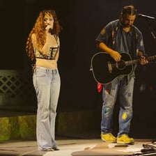 Singer-songwriter Noah Kahan performing on stage