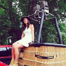 Pilot standing in the basket of a hot air balloon