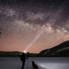 A person looking up at stars in the night sky.