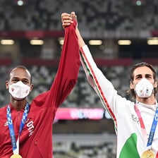 Two athletes celebrating a shared championship victory.