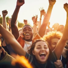 A visibly happy person celebrating with raised arms.