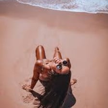 A person sunbathing on a beach.