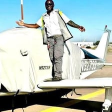 A pilot operating a small single-engine monoplane.