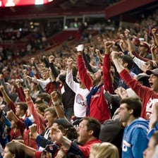 A large crowd erupting in celebration at a sporting event.