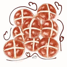 Hot cross buns displayed in a bakery.