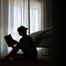 A solitary person sitting alone in a quiet room