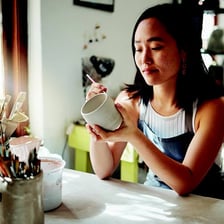 A person happily taking up and enjoying a new hobby