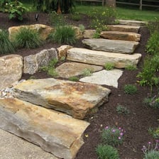 A broad, thick slab of stone.