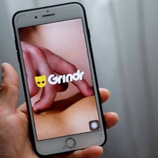 A smartphone displaying dating app icons