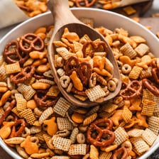 A snack mix containing square Rice Chex cereal pieces and pretzels.
