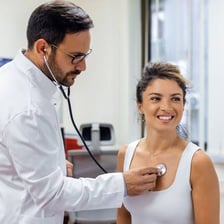 A primary care physician examining a patient during a routine checkup.