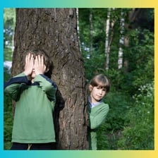 A child discovering another player during a game of hide-and-seek.