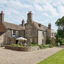A large historic manor house viewed from outside.