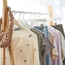 A rack of women’s clothing labeled for petite sizes.