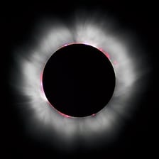 The Sun’s glowing corona extending around its visible disk.
