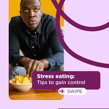 A person eating snacks while working at a desk and appearing stressed.
