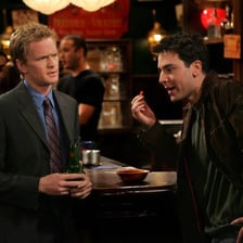 Two people talking flirtatiously in a bar