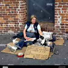 A person asking passersby for spare change.