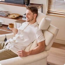 A person leaning back in a comfortable chair.