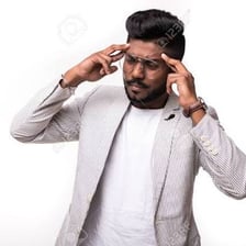A person touching their head while thinking.
