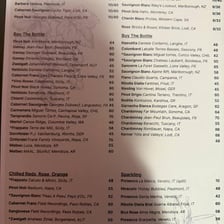 A restaurant wine list with a section labeled for red wines.