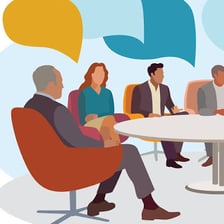 A club president leading a meeting at a table.