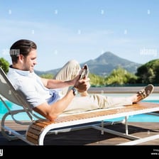 A person reclines on a lounge chair.