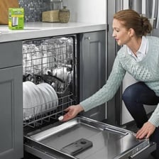 Clean plates and glasses being removed from a dishwasher