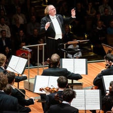 John Williams conducting an orchestra performing film music