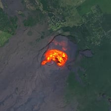 A volcano erupting with lava and a plume of ash