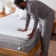 A padded mattress cover on a bed