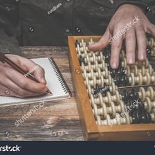 A person counting a group of objects.