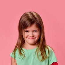 A mischievous child with an impudent expression