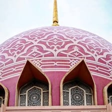 A mosque topped by a large rounded dome.
