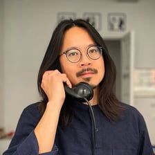 Stand-up comedian Sheng Wang performing on stage