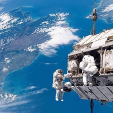 An astronaut working outside a spacecraft in orbit.